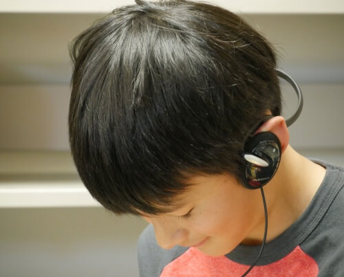 Zander Chao listens to a book on CD while reading it at the same time.