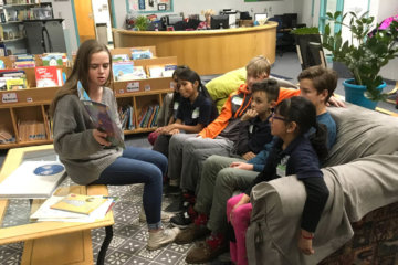 Rebecca Kerr, James Doolittle, and Grady Behrhorst used children's books to help talk about personal stories of immigration with a group of third graders at Castro Elementary School in Denver.