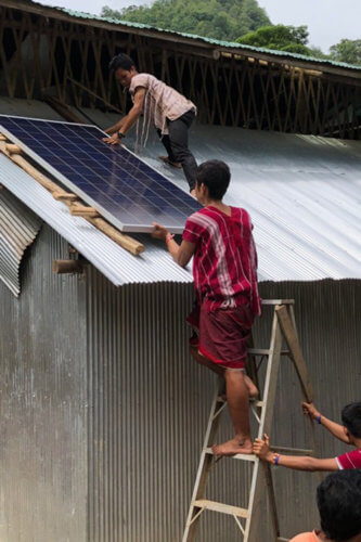 Installing the solar panels on a school for Karen refugees