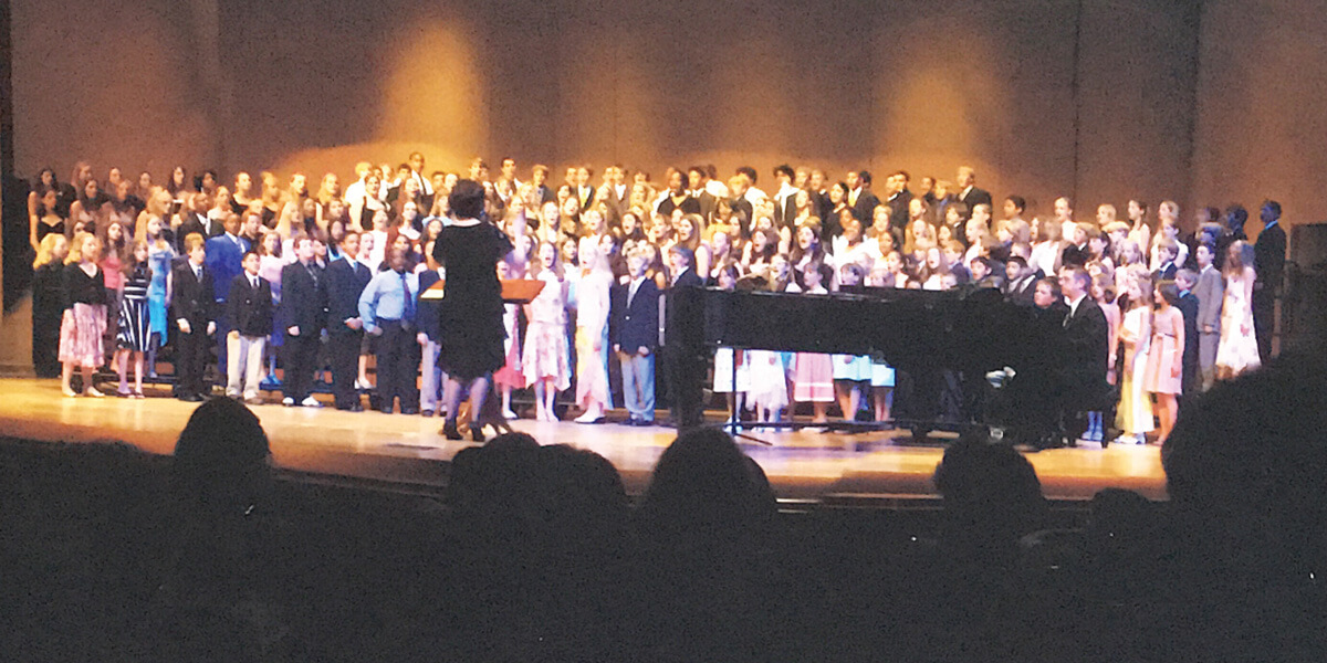 Cindy conducting CA students at the University of Denver Newman Center for the Performing Arts