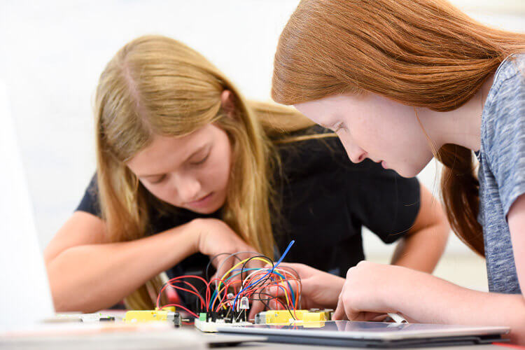 Upper School students work with circuit boards