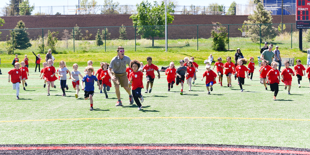 Head of School Dr. Mike Davis falls behind in the traditional race with the Kindergartners.