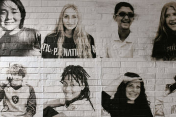Outdoor portraits are displayed on CA's Upper School building in November 2021.