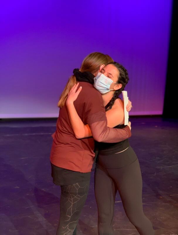 CA Junior Sasha Yuffa hugs dance teacher, Emily Hoch-Windus, after being awarded one of only four scholarships at the CoDEO conference.