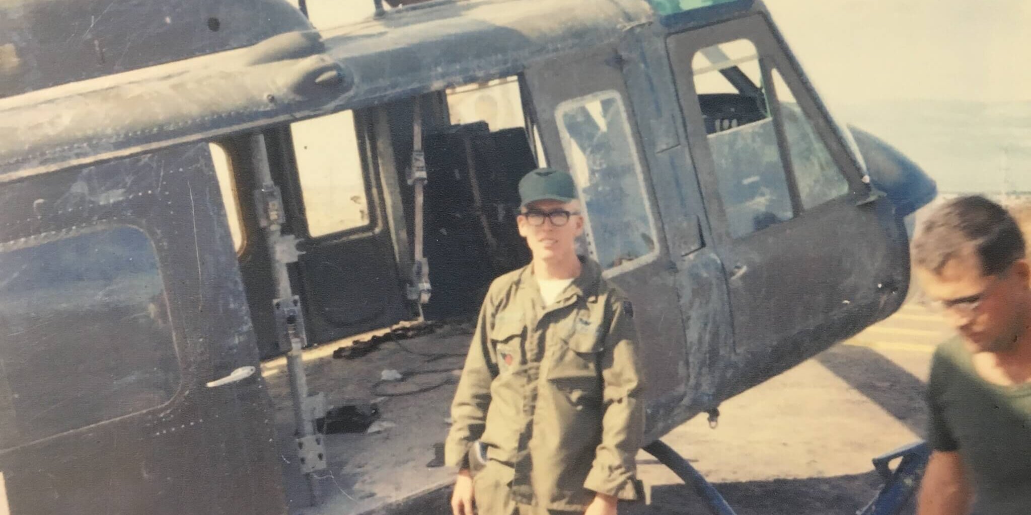 CA grandfather and veteran Paul Harpole, a Dust Off crew chief, with his Huey helicopter in Vietnam.